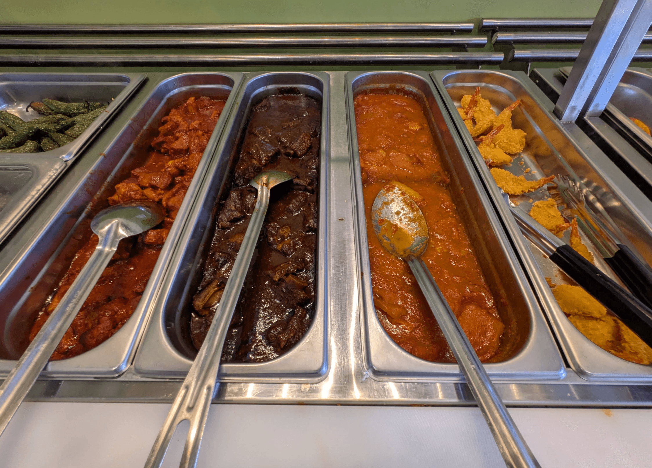 Weekend All-You-Can-Eat breakfast buffet warming pans with mole, birria and traditional Mexican stews at Roberta's Cocina Mexicana